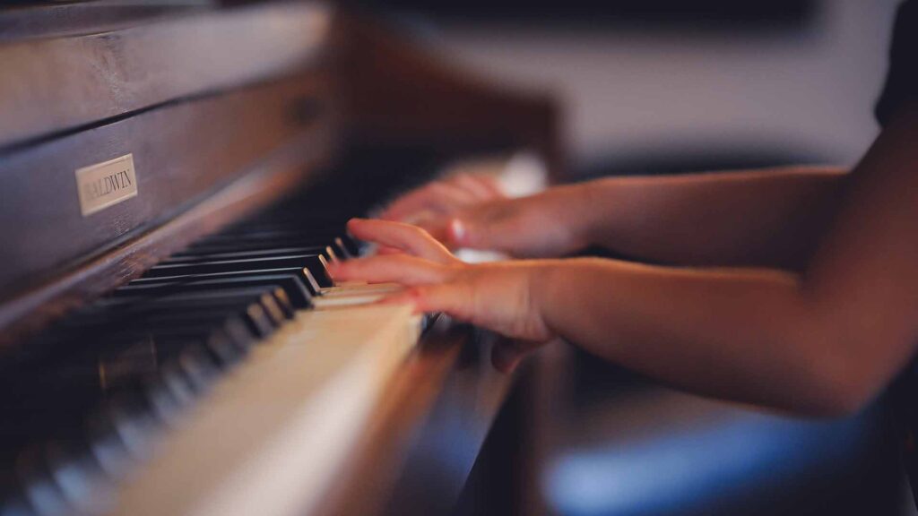 young child playing piano