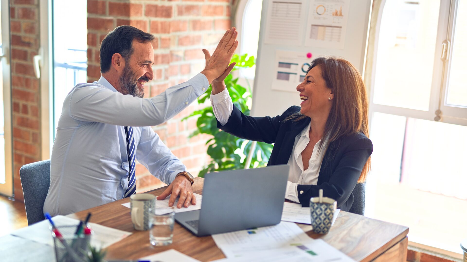 photo of man and woman giving a hign-five